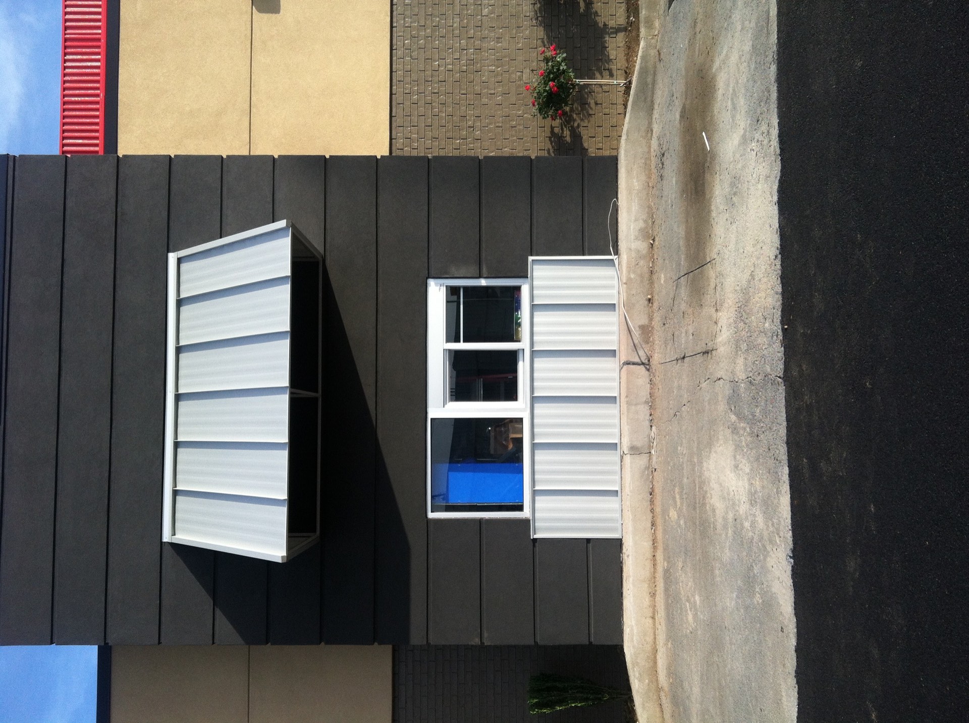Commercial box gutter and downspout system on a retail building